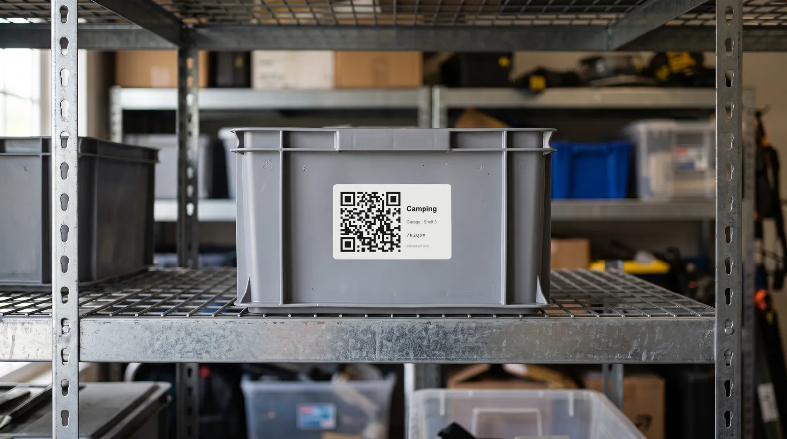 A gray storage bin on a garage shelf with a WhereKept QR code label on the front